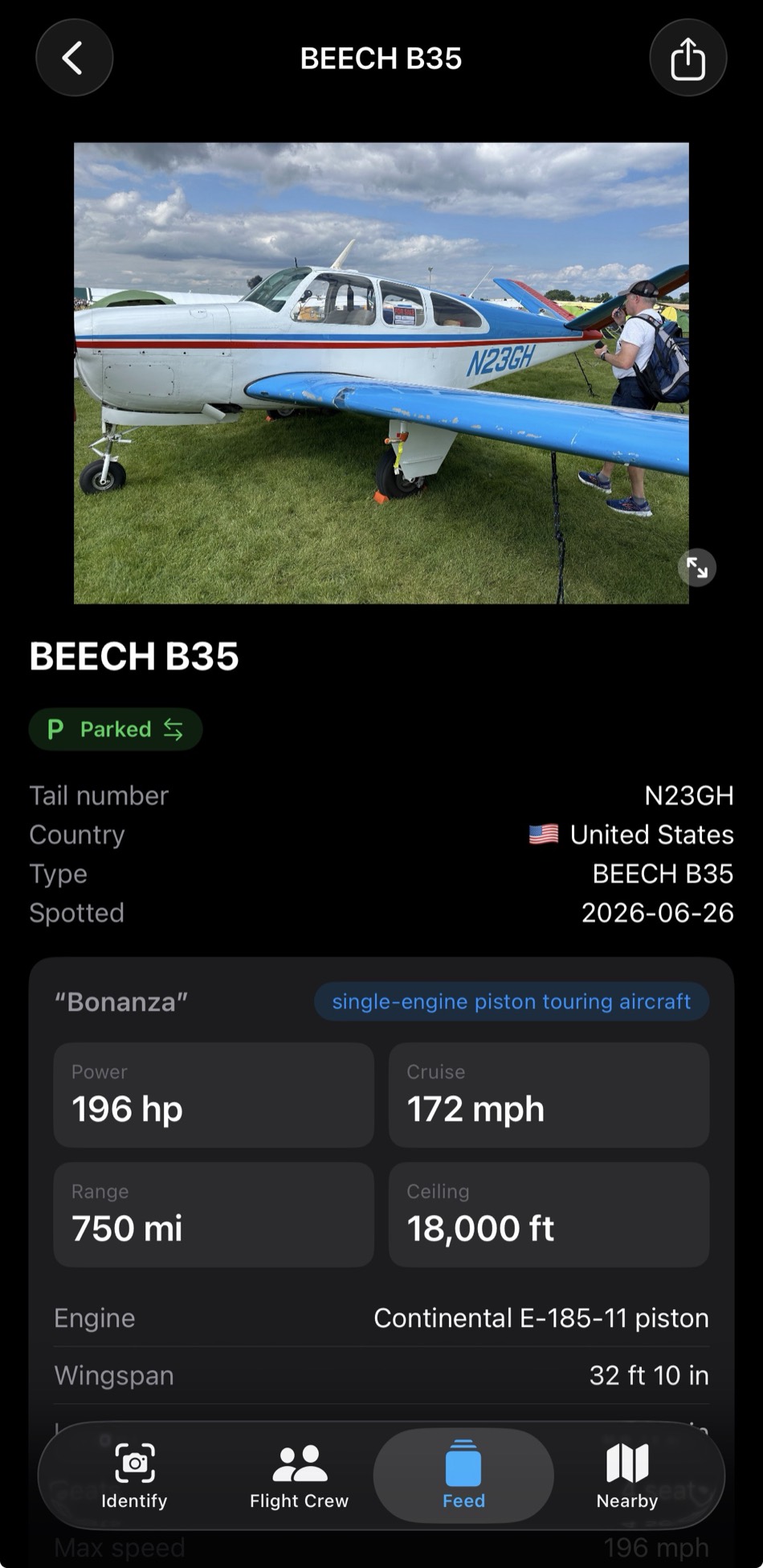 The Fly-in Spotter app showing a Beech B35 Bonanza (N23GH) parked at a fly-in — tail number, type, and a spec card with power, cruise, range, and engine — above the Identify, Flight Crew, Feed, and Nearby tabs